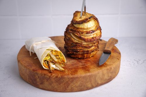 Brown board with celeriac shawarma stack on top