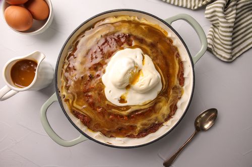 Baking tray of Parsnip Sticky Date Pudding topped with icecream