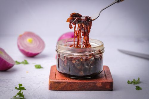 Fork scooping red onion marmalade