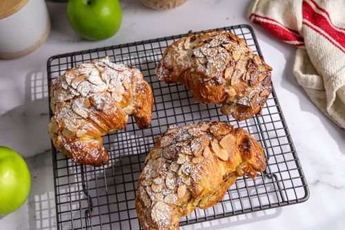 Tray with freshly baked almond croissants