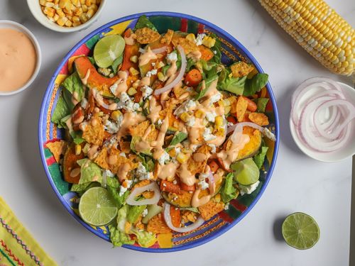 Serving platter of corn, pumpkin, carrot salad