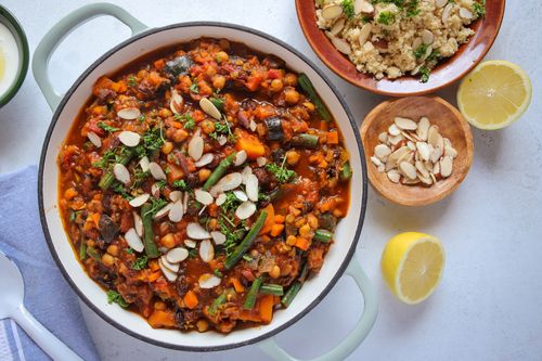 Casserole dish of vegetable tagine with serving accompaniments