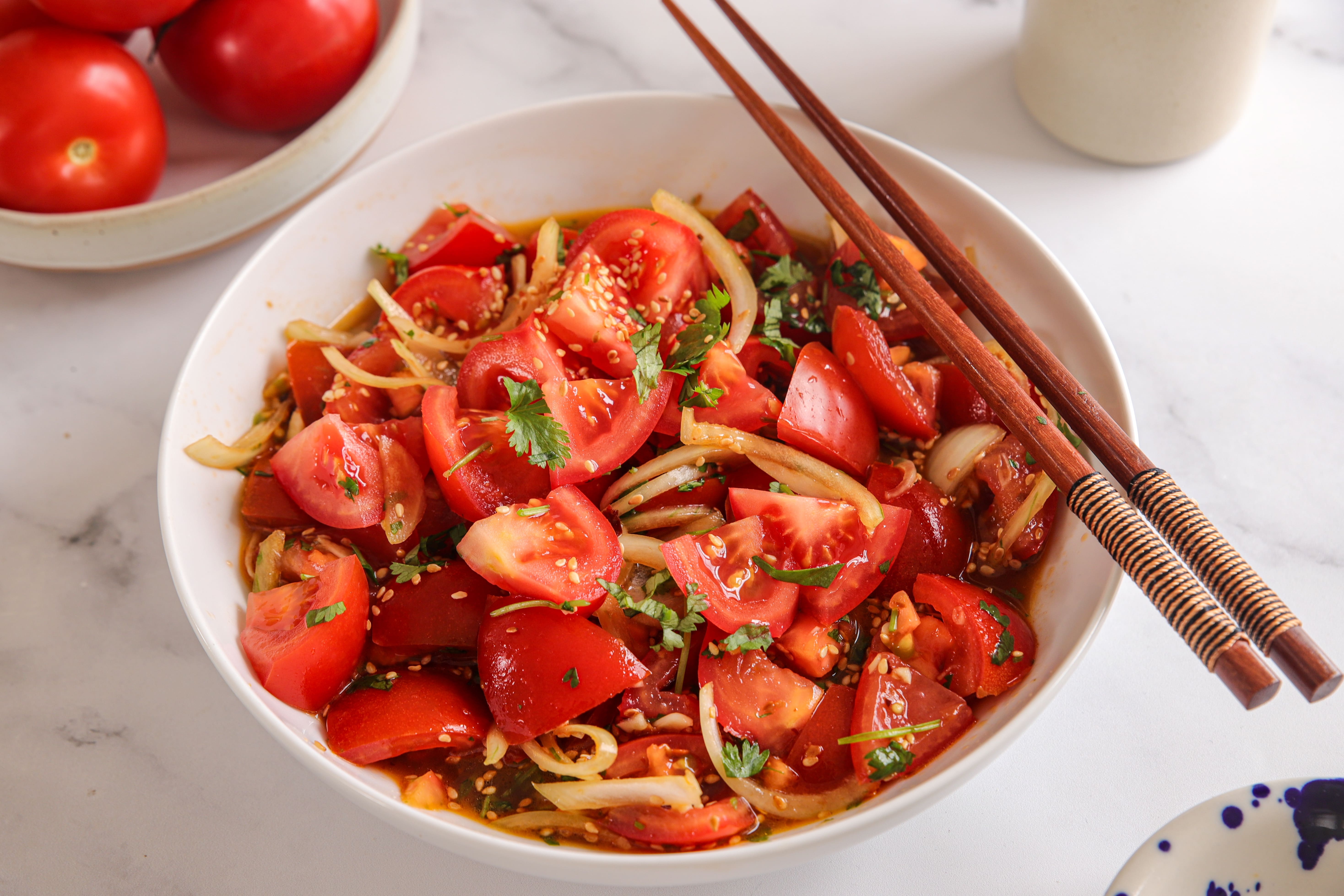 Chunky red tomatoes and sliced onions in a light soy and sesame dressing, topped with fresh coriander and toasted sesame seeds.