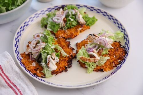 Golden, crispy kumara taco shells cooling in a muffin tin, ready to fill