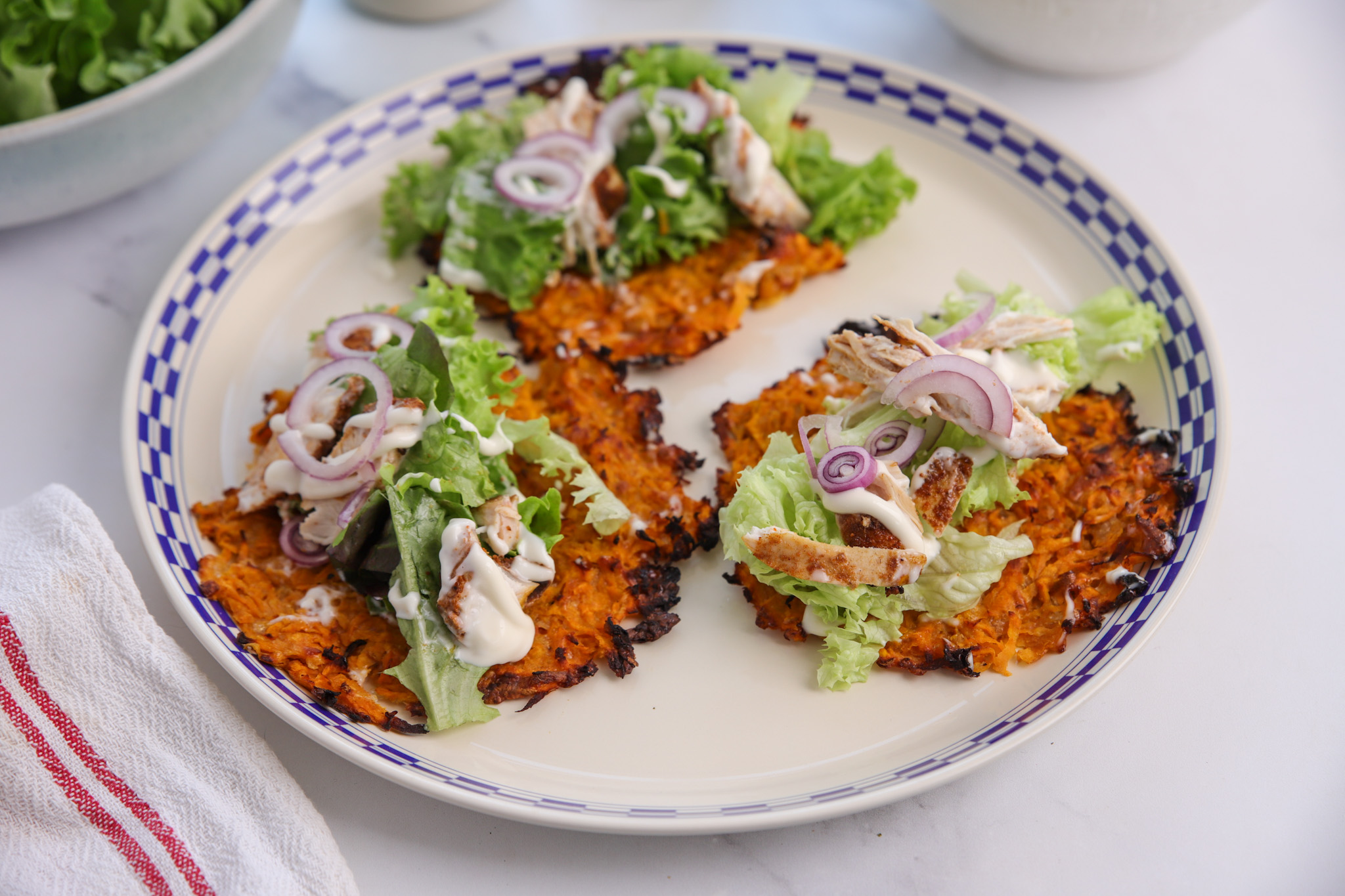 Golden, crispy kumara taco shells cooling in a muffin tin, ready to fill