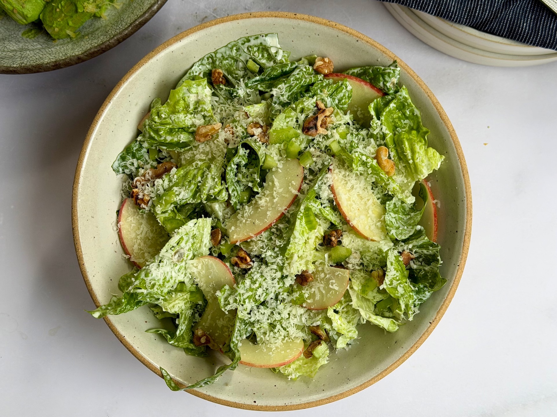 Cos lettuce salad with thin raw apple slices, toasted walnuts and shaved parmesan in a creamy caper dressing.