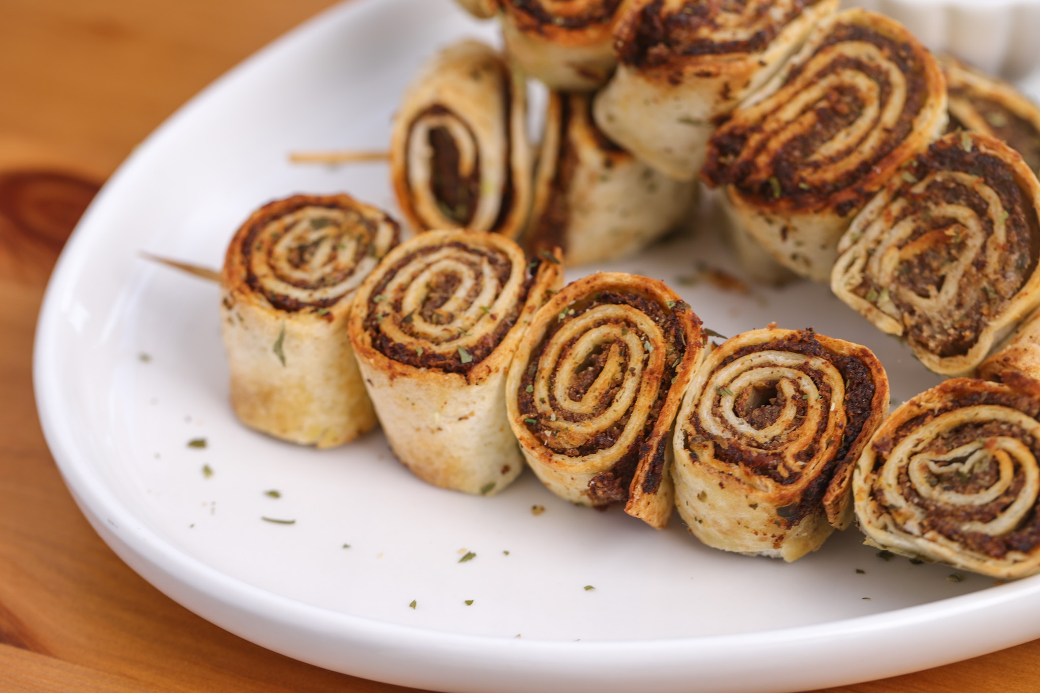 Skewered mushroom and walnut roll-ups brushed with garlic butter, served with avocado dipping sauce