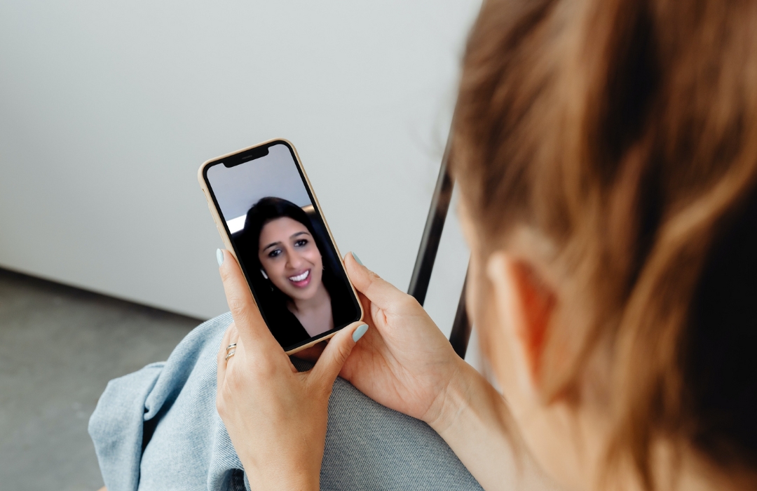A person on a video call with their doctor