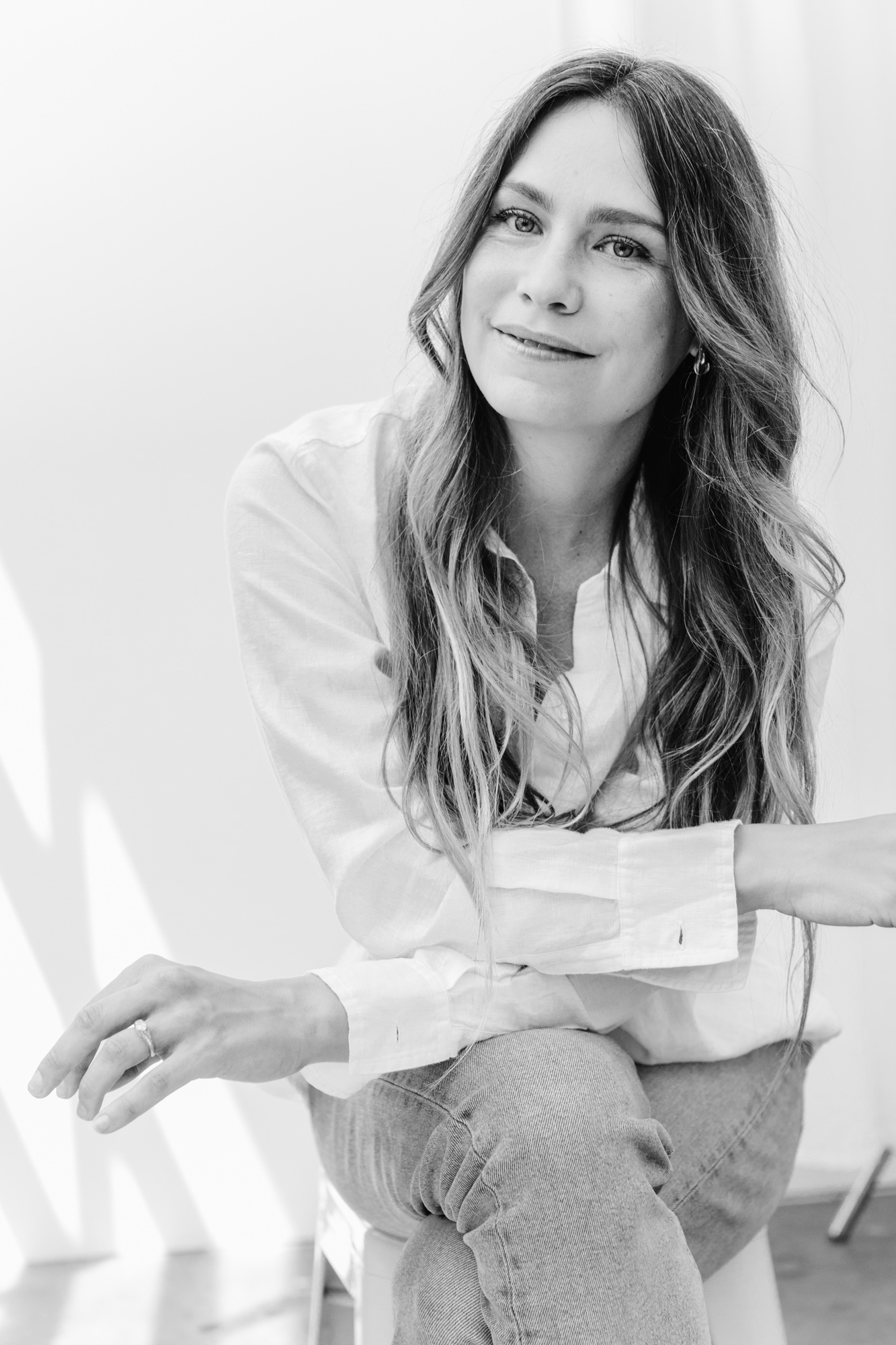 Black and white portrait of a woman seated, looking at the camera