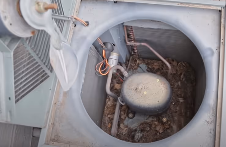 Open AC dirty with dirt and leaves and needing to be cleaned