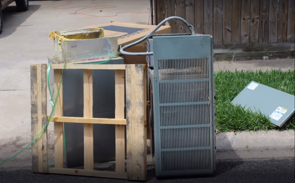 Old air conditioner sitting on curb outside of Corpus Christi home