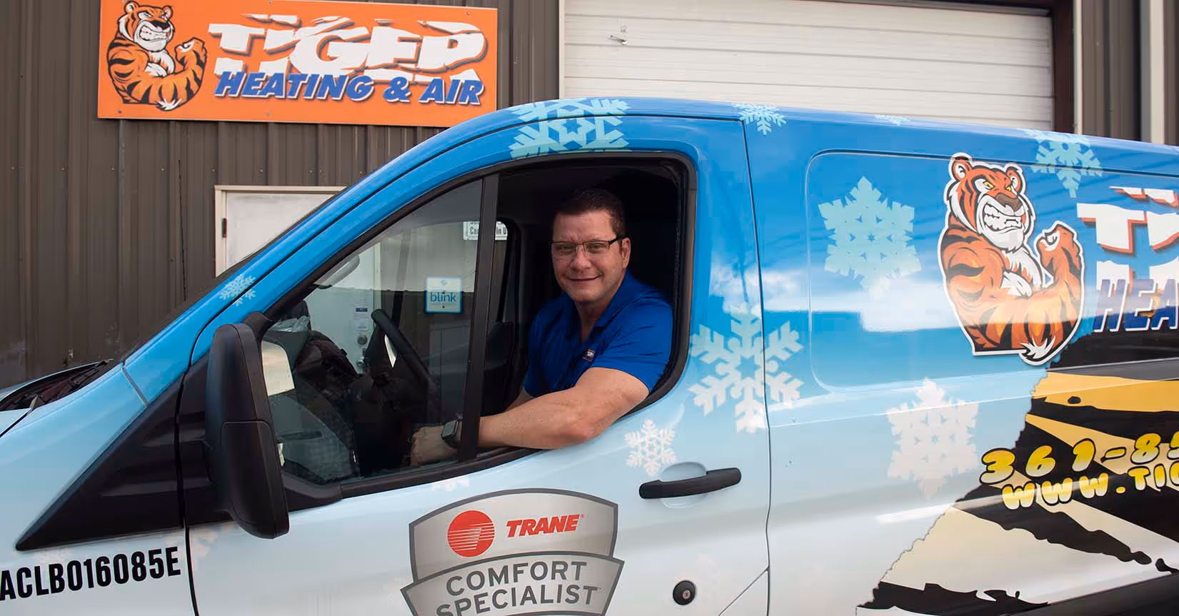 AC technician & owner driving Tiger Heating & Air HVAC van in Corpus Christi