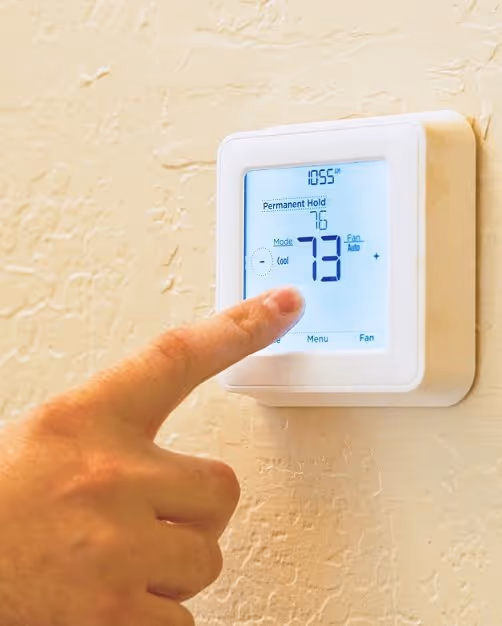 Thermostat set to 73 degrees, something to check when an AC blows hot air