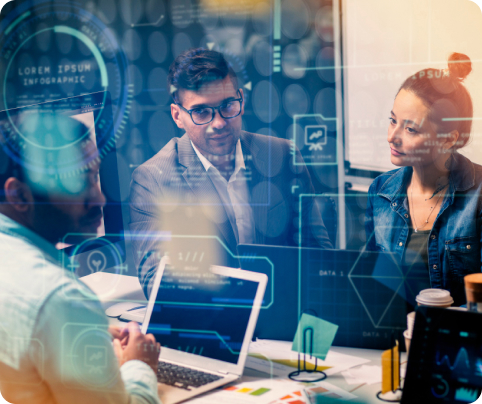 Three professionals discussing data and analytics displayed on transparent screens in a modern office.