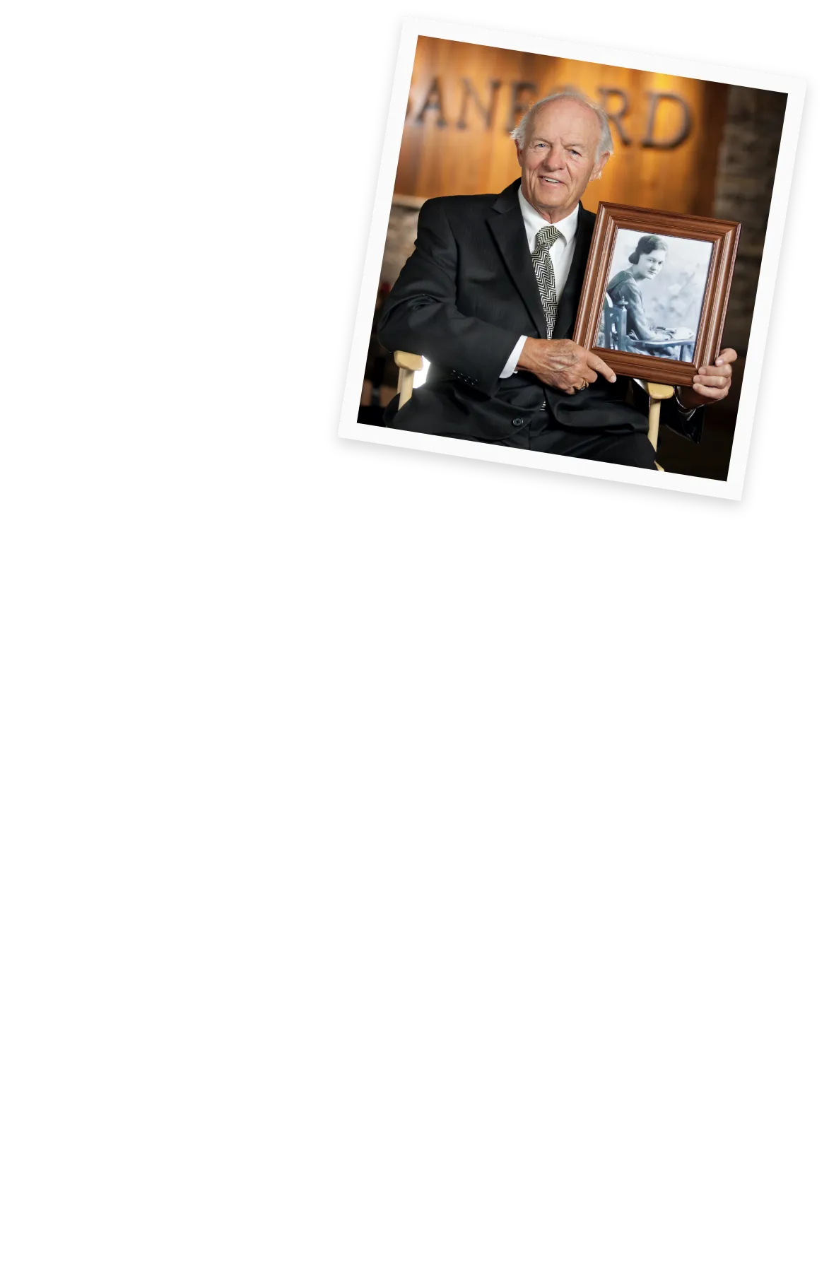Denny Sanford holding image of his mother.