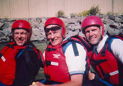 Denny Sanford white water rafting with sons.