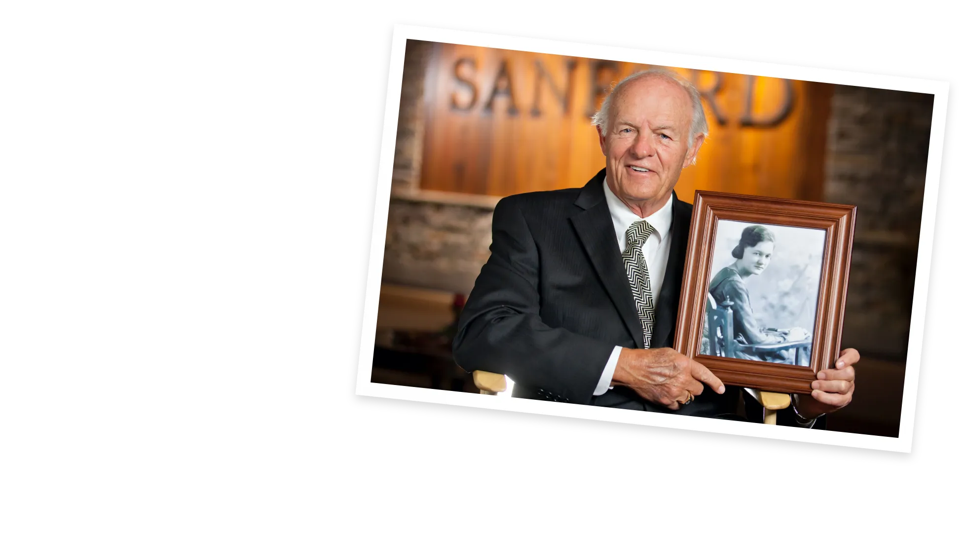 Denny Sanford holding image of his mother.