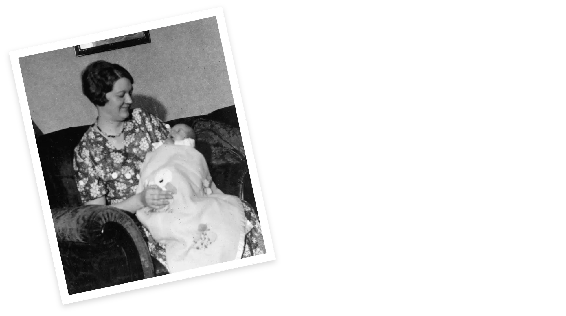 Denny Sanford being held as a baby by his mother.