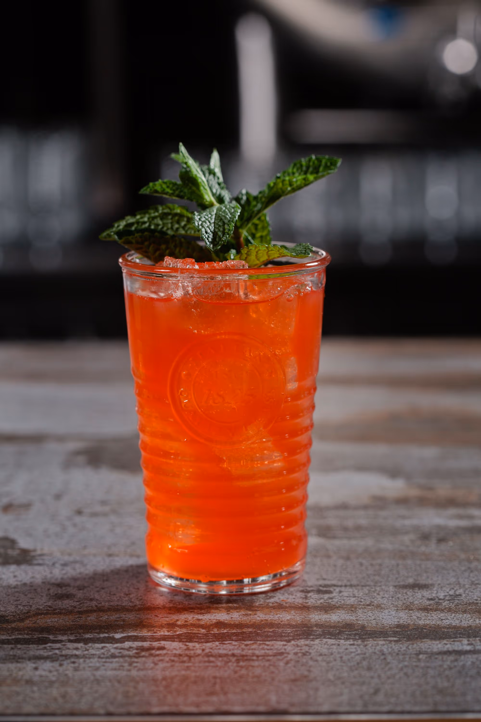 bright red cocktail with mint garnish