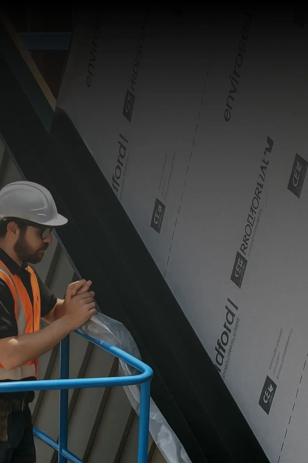 Worker installing sarking and moisture barrier for cladding replacement to ensure weatherproofing and compliance in Sydney buildings.