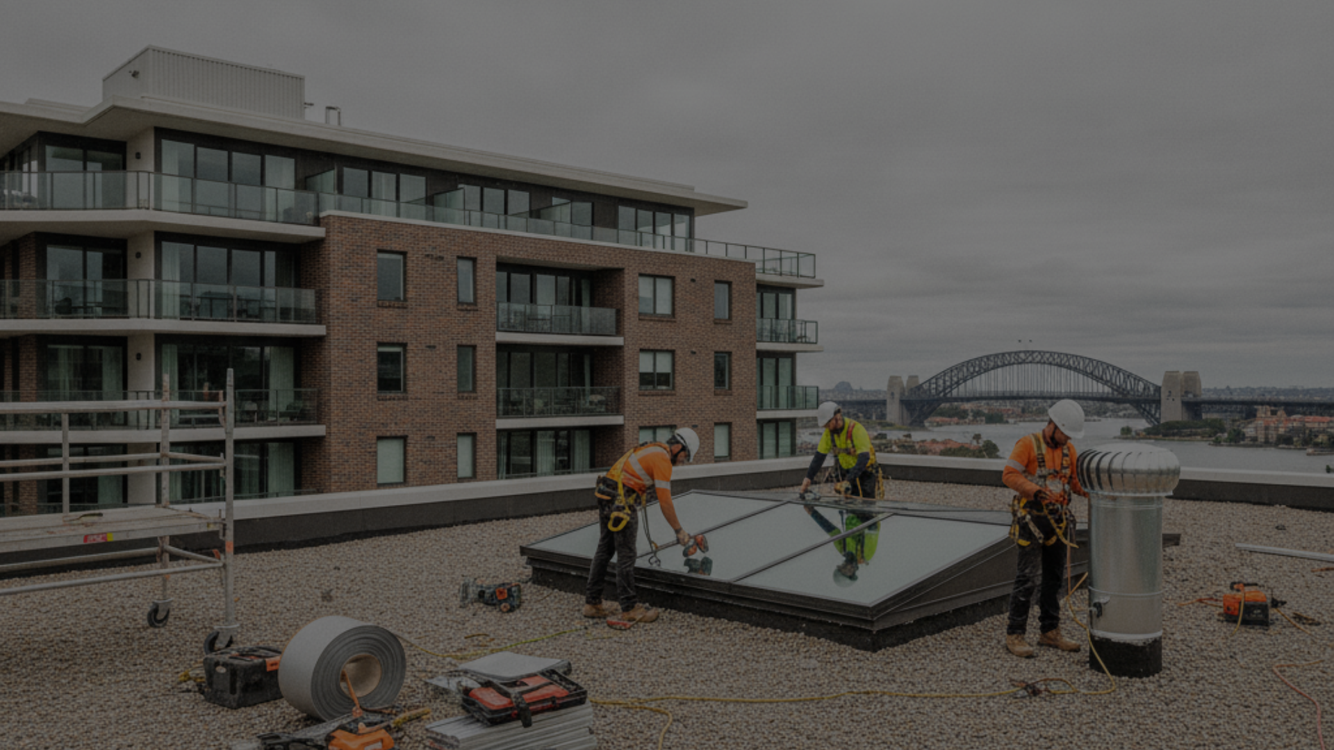 Workers installing fire-rated cladding panels on Sydney apartment building facade