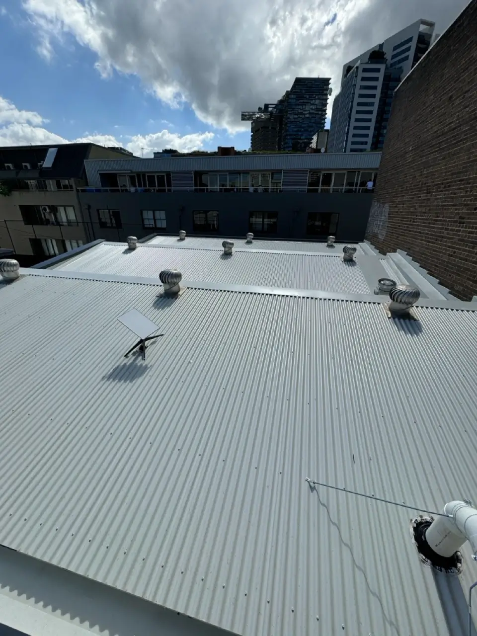 Roof and drainage upgrade at Henrietta St, Chippendale — completed metal roof with upgraded drainage falls