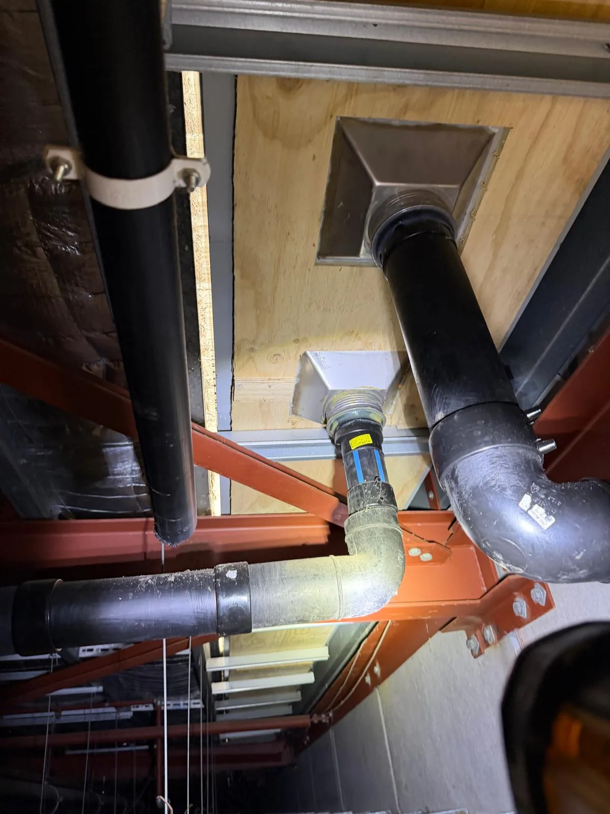 Siphonic drainage re-engineering at John St, Warners Bay — new siphonic pipework and outlet connections above the ceiling structure