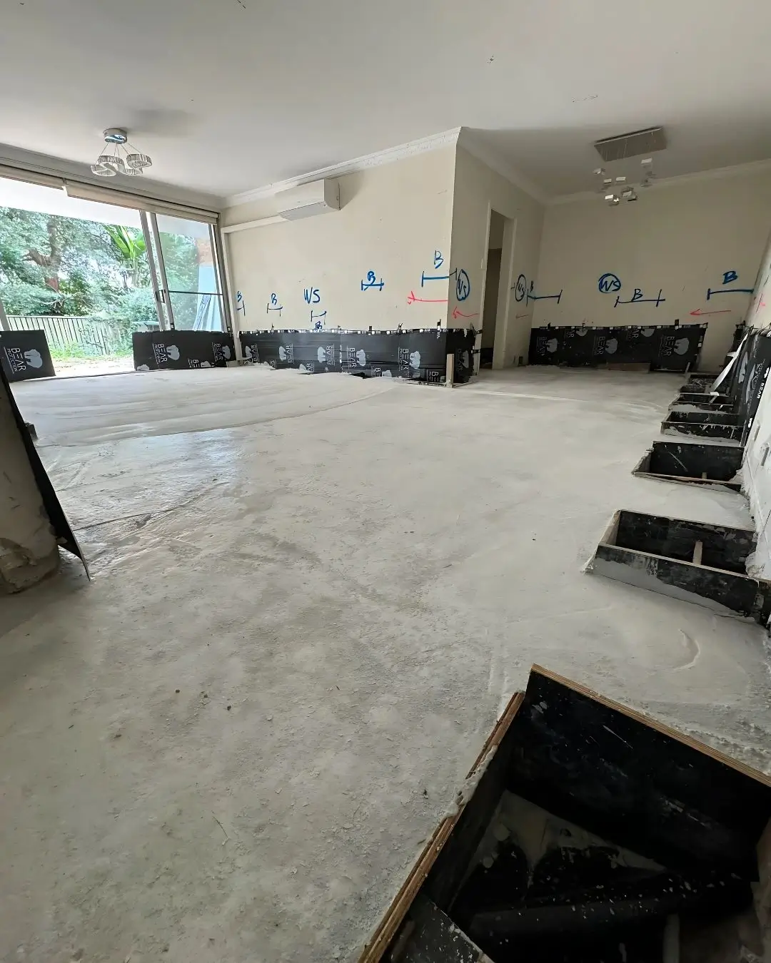 Structural slab remediation at Pacific Hwy, Killara — new concrete slab poured and curing inside the apartment