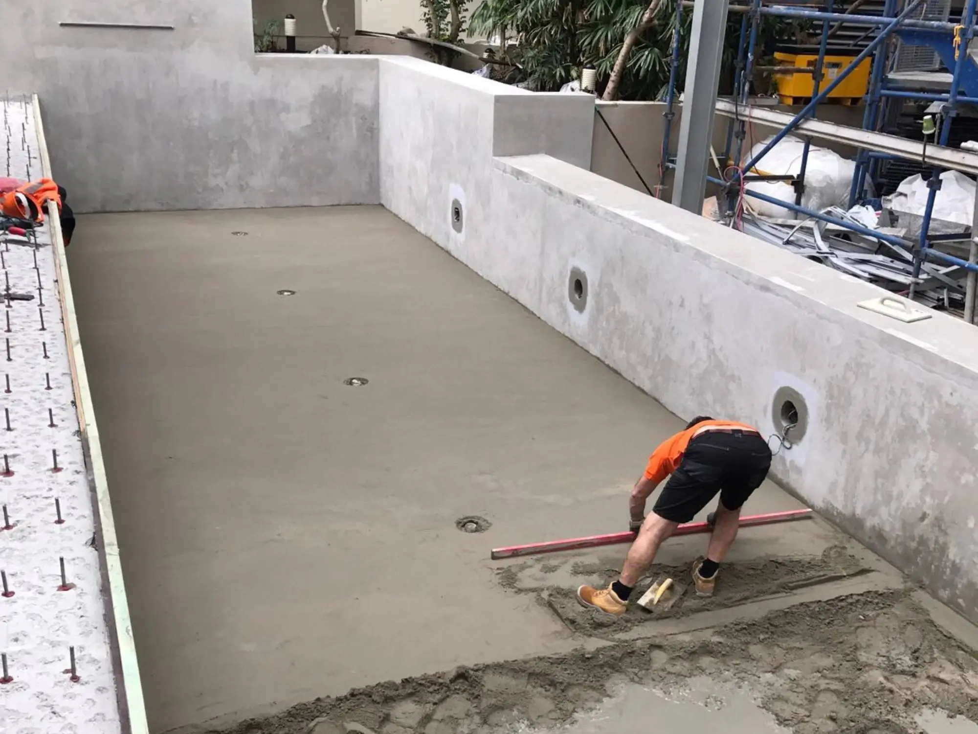 Pool remediation at Shelley St, Sydney CBD — screeding the new pool floor after removal of the failed finishes