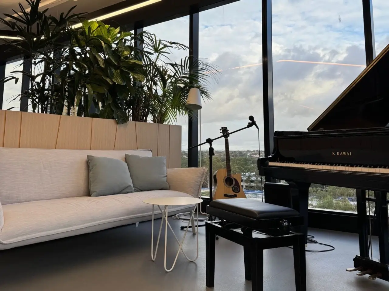 Office fit out at Precinct Co-Working, Olympic Park — lounge area with piano in the completed breakout space