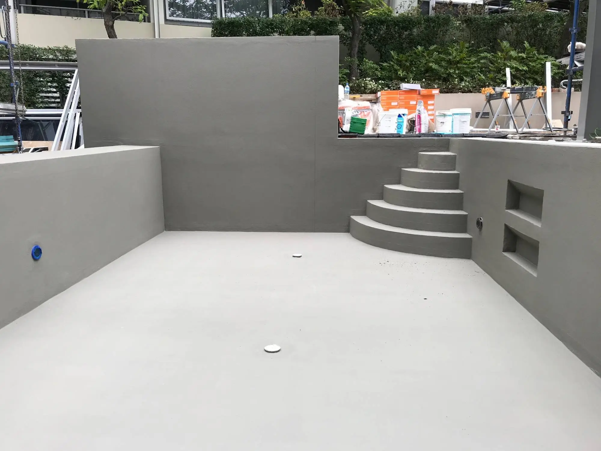 Pool remediation at Shelley St, Sydney CBD — rendered pool shell and stairs ready for final finishes