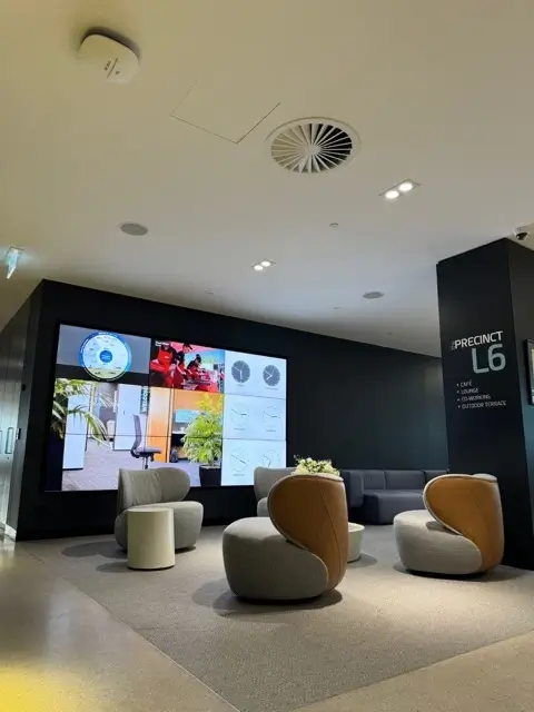 Fit out at Precinct Co-Working, Olympic Park — media wall and lounge seating in the Level 6 lobby