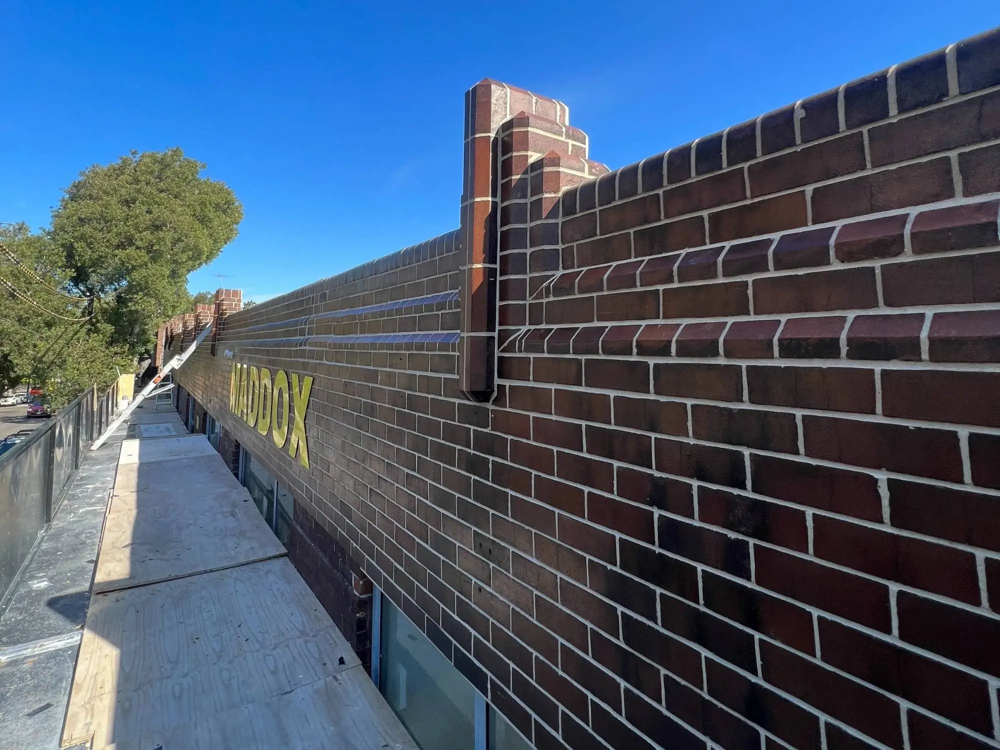 Heritage brick restoration at Maddox St, Alexandria — restored face brick boundary wall along the laneway