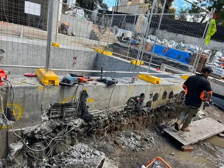Pool remediation at Coolong Rd, Vaucluse — excavation alongside the pool shell exposing the edge beam for repair
