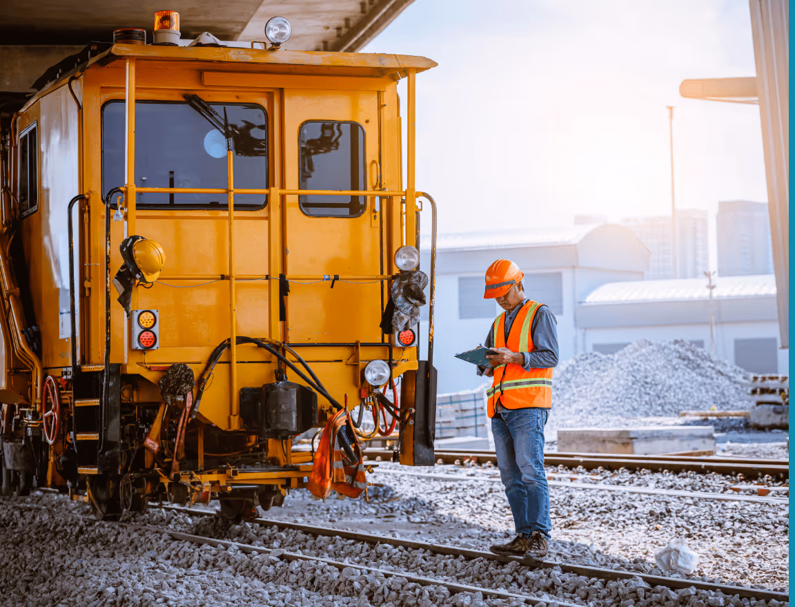 rail safety worker in high vis inspecting a train