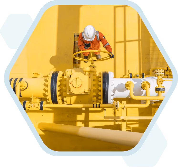 A worker in protective gear on a yellow industrial site