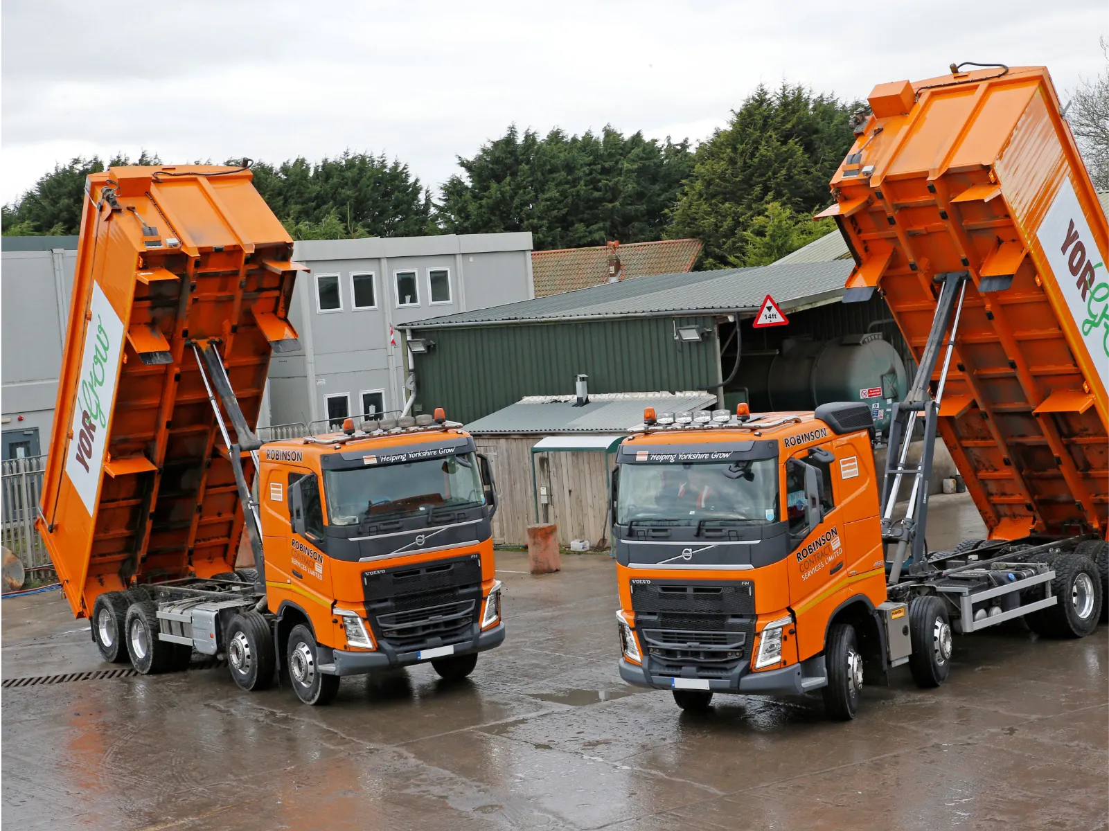 Harsh hydraulic truck hoist raising a loaded dump bed