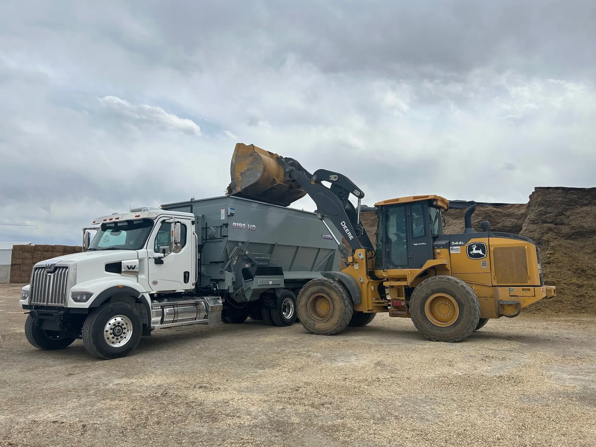 Harsh truck-mounted feed mixer at a feedlot