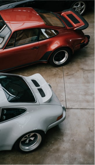 Rear of two Porsche cars