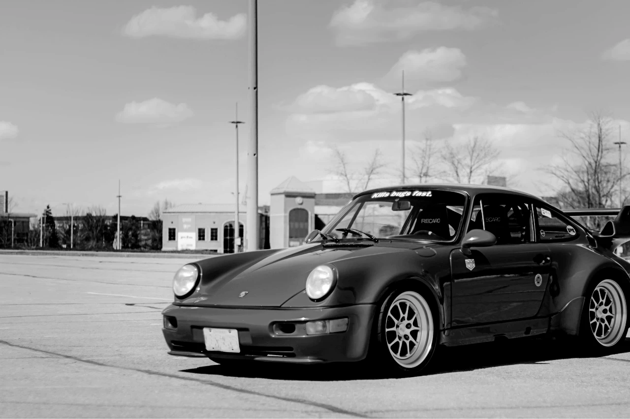 A black and white image of a Porsche