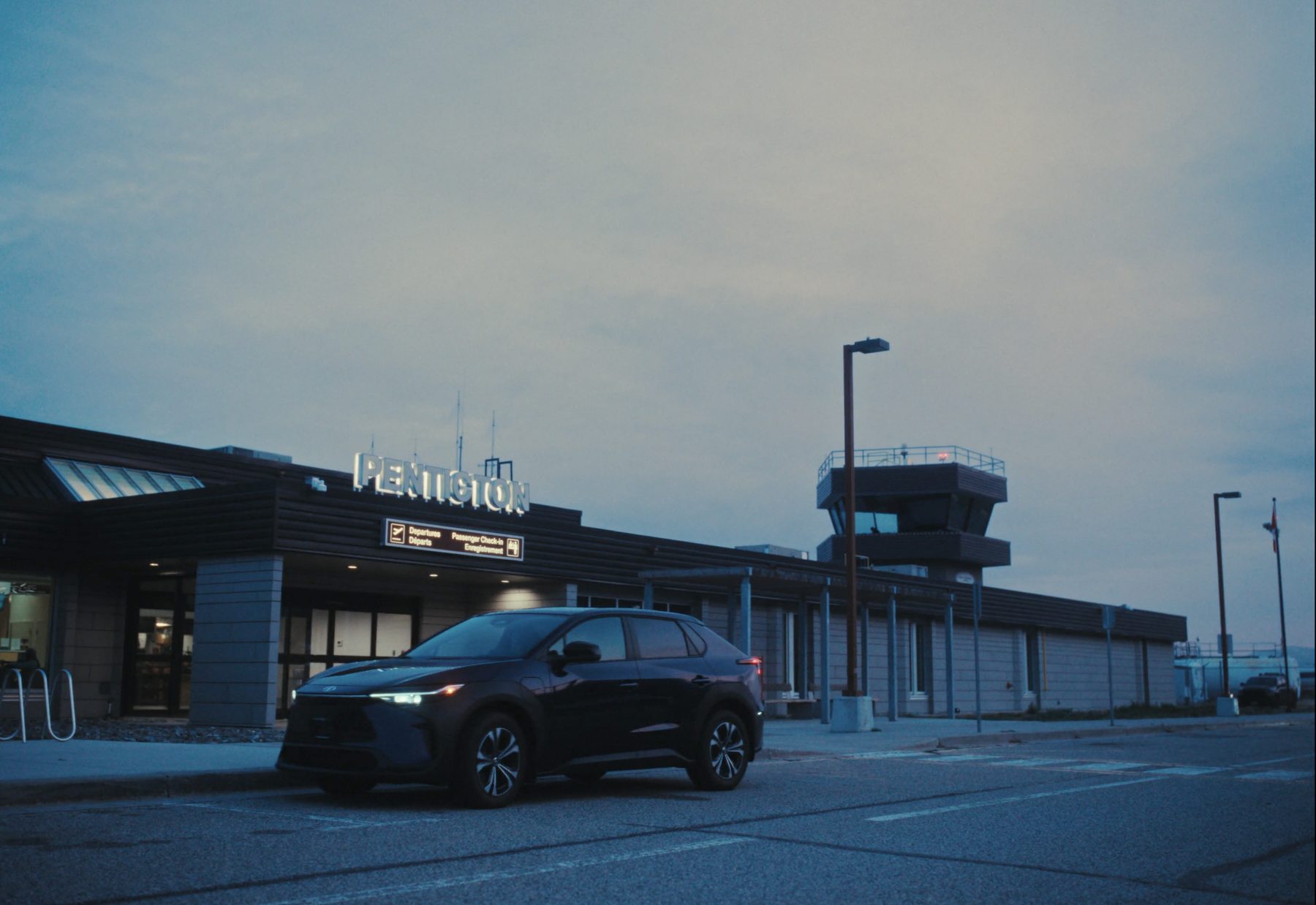 Frame from Save Time: an SUV outside Penticton airport at blue hour