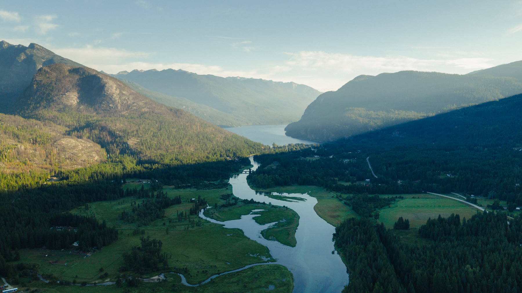 The Slocan Valley from above, the river winding toward the lake
