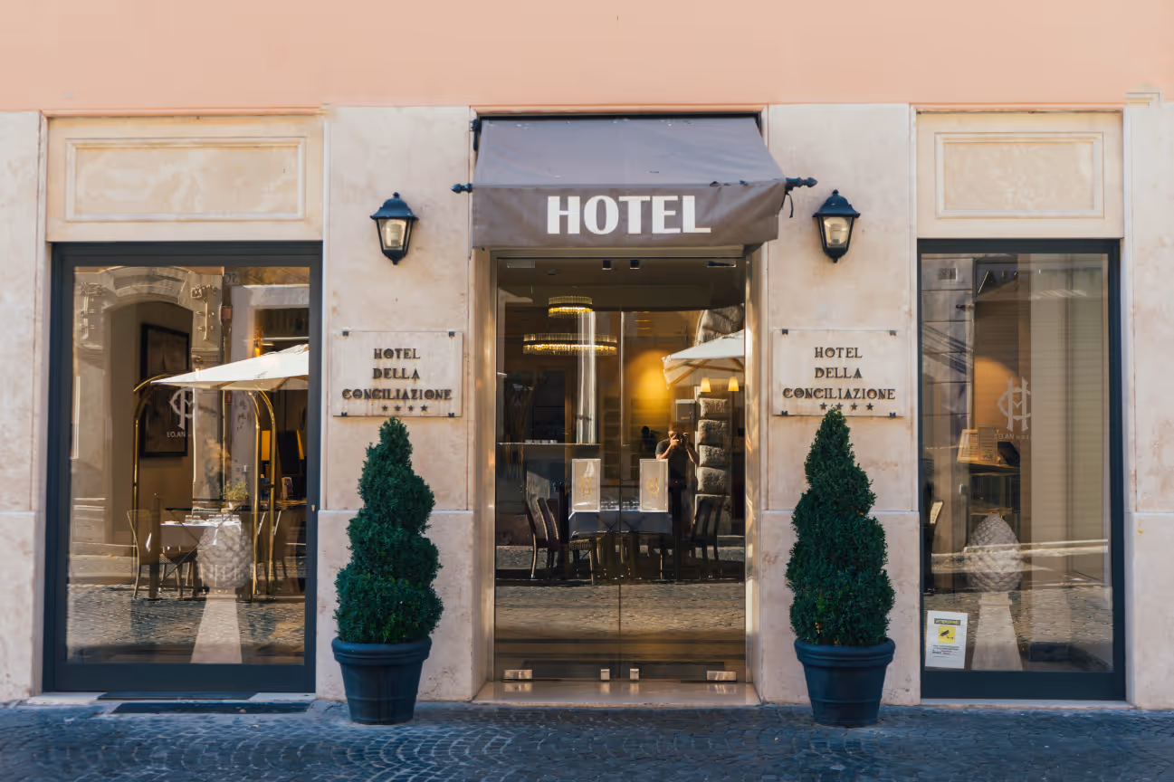 boutique hotel with pines at entrance