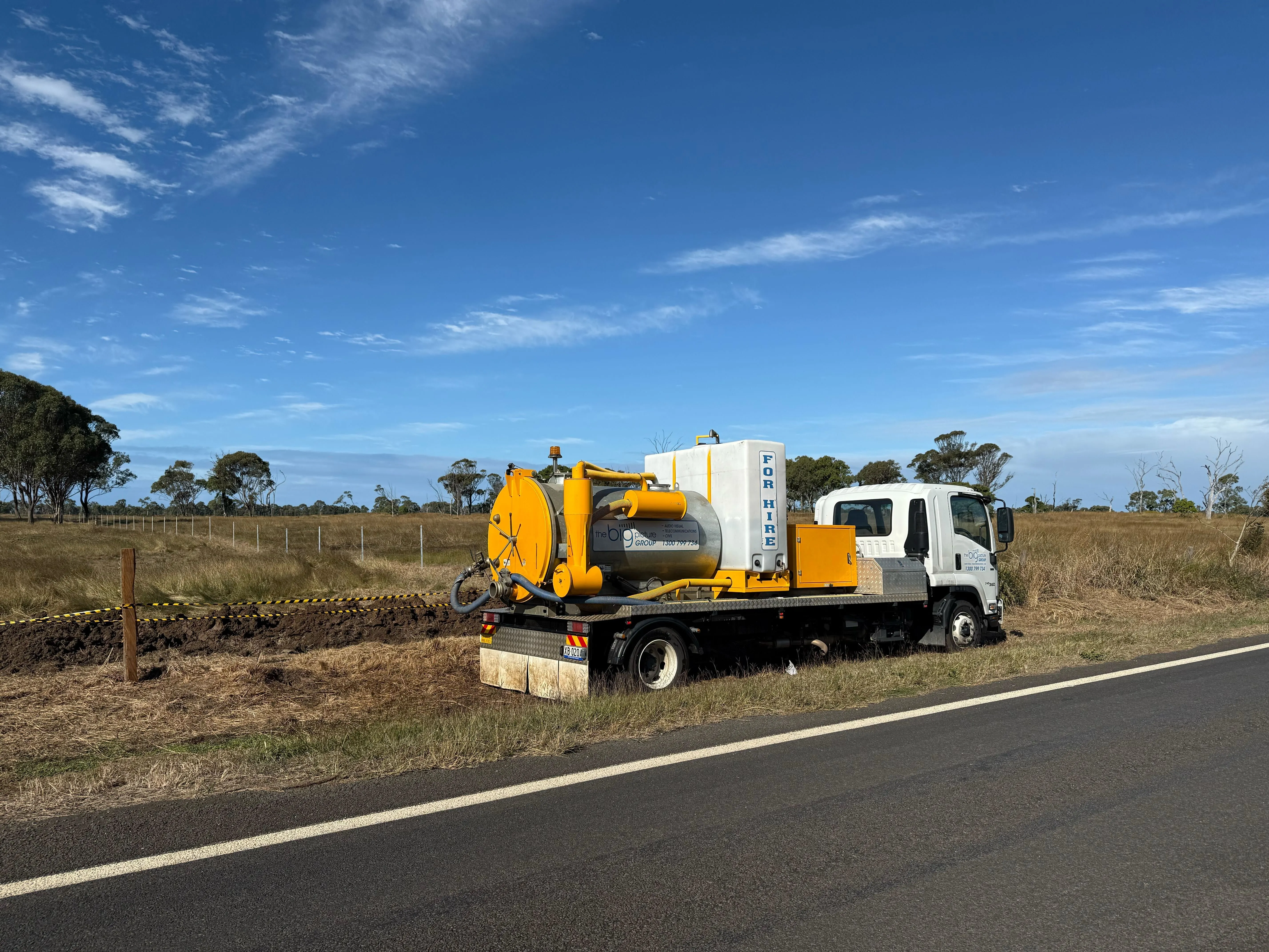 Vac truck beside a road