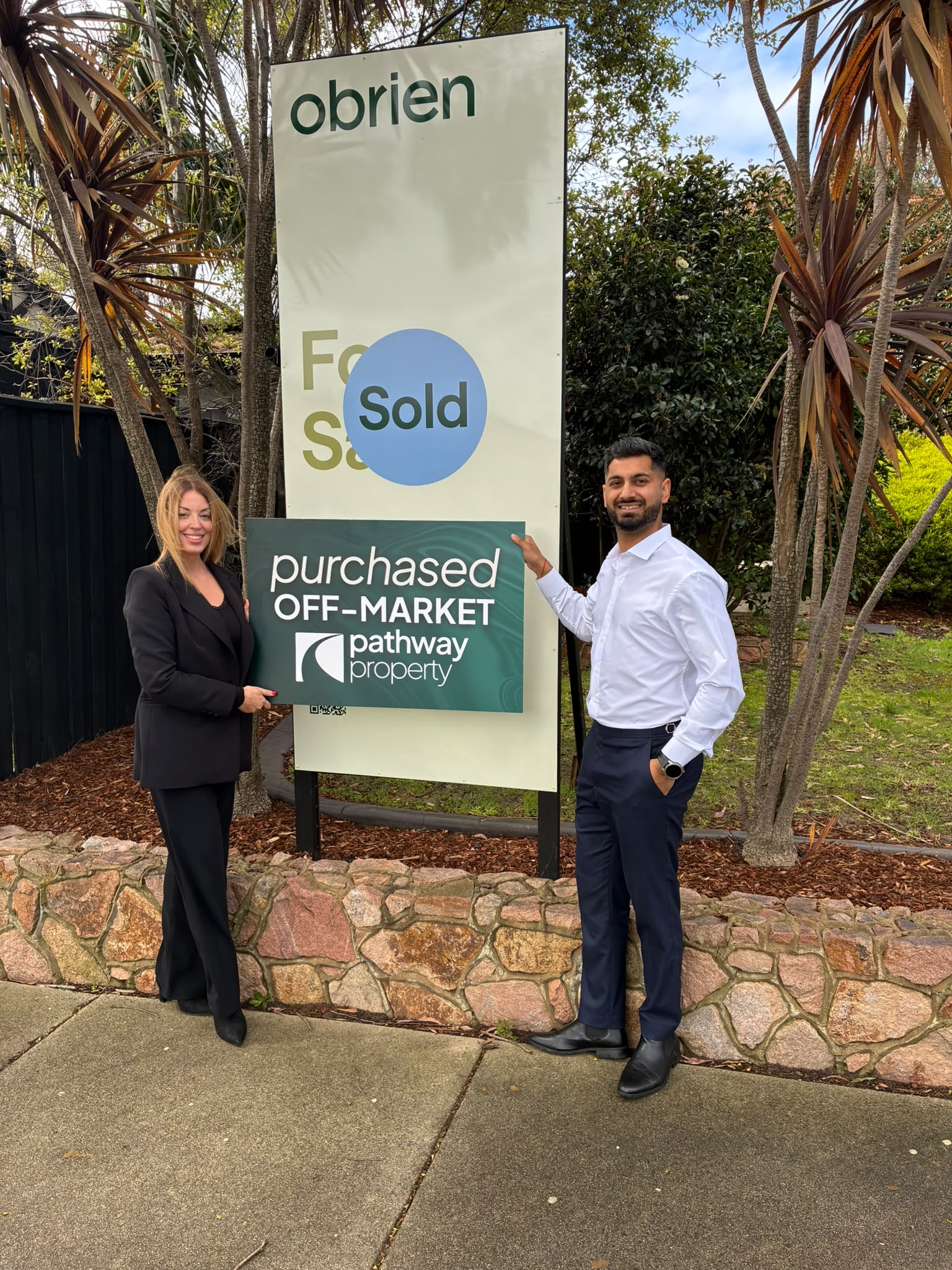 A Pathway Property client outside the home they purchased