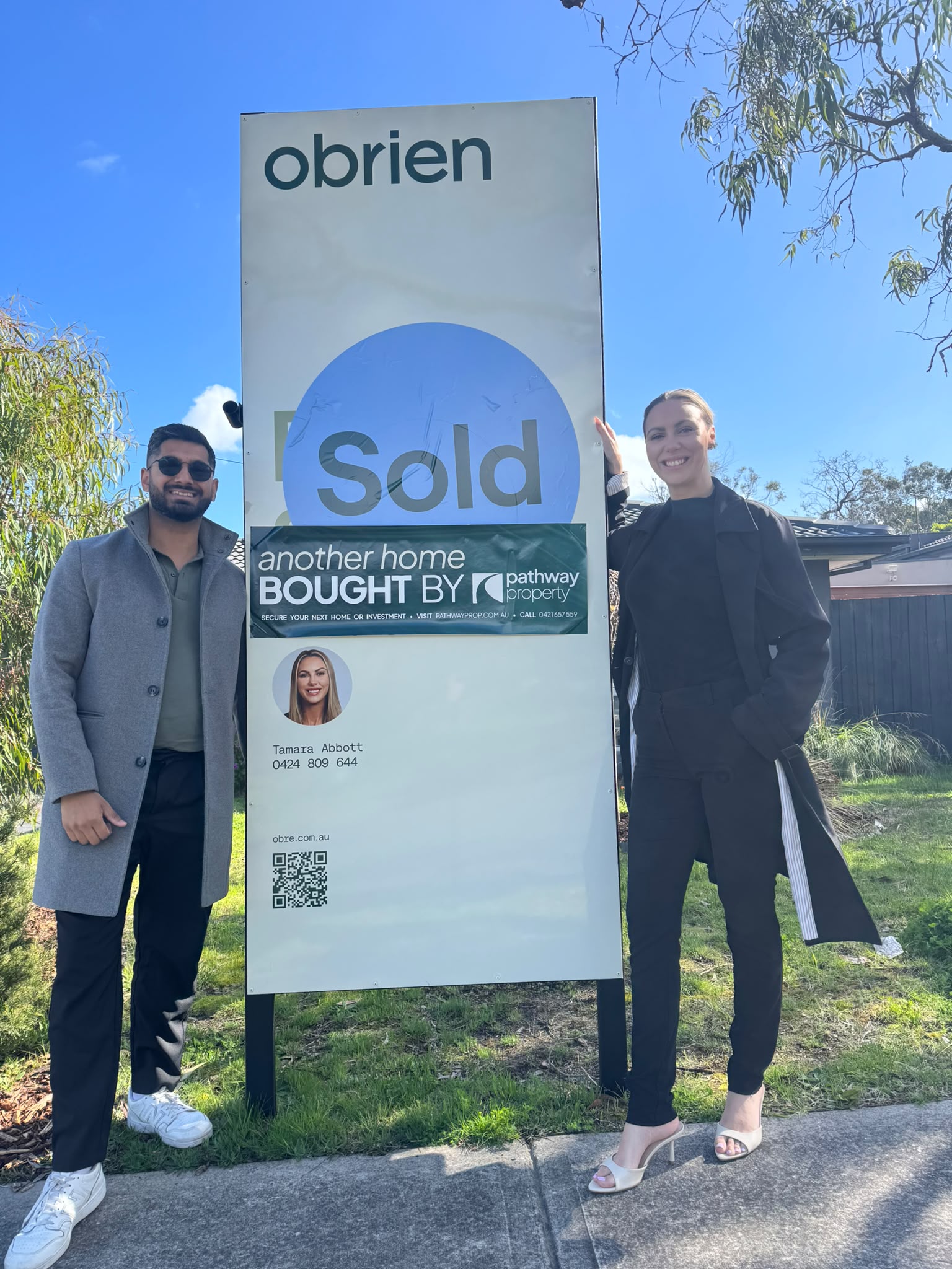 A Pathway Property client outside the home they purchased