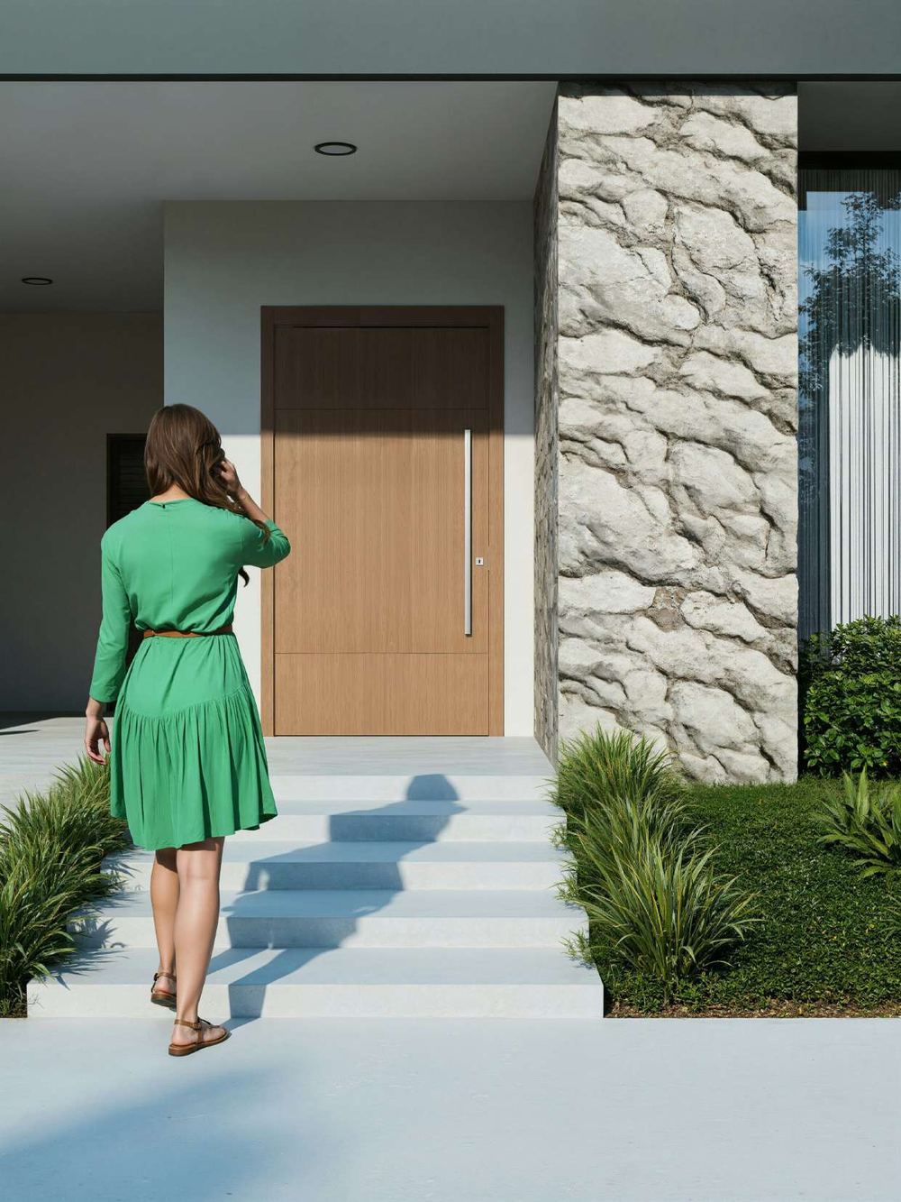 A woman walking up the steps to the front door of a home