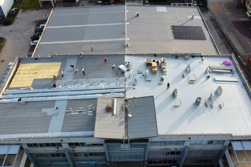 Aerial view of a commercial and industrial roof replacement in progress by Element Metal Roofing.