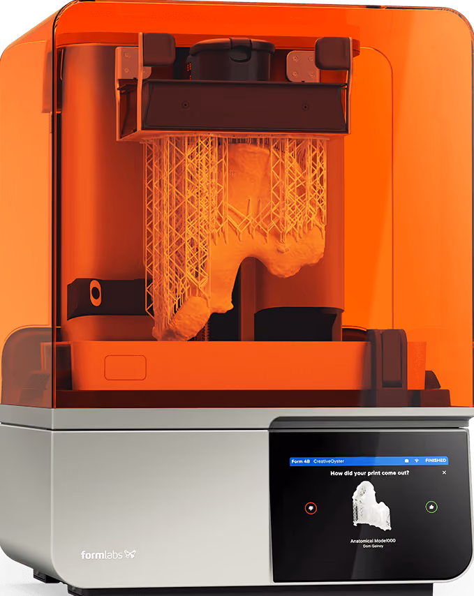 Formlabs 3D printer with orange cover producing a detailed anatomical model on touchscreen display.