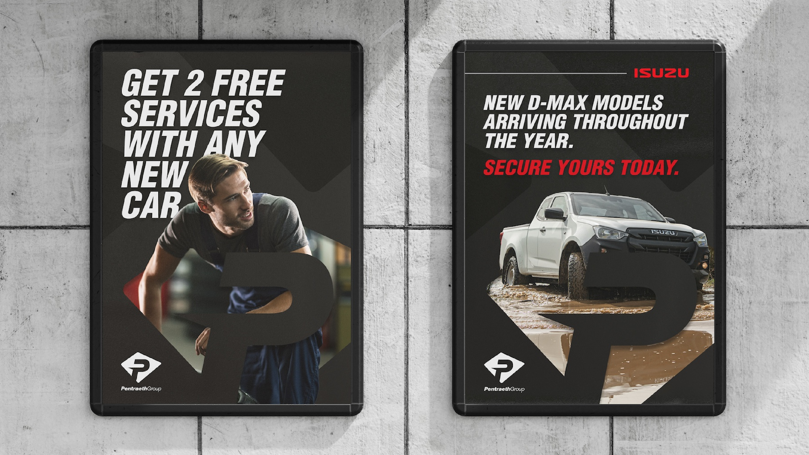 2 Pentraeth Motor Group posters displayed on a tiled wall